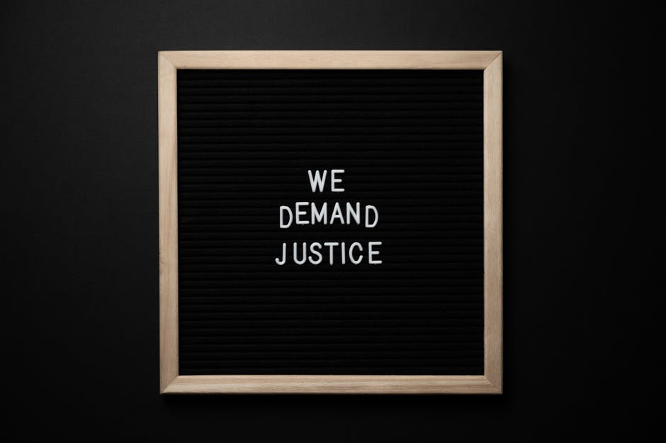 Blackboard with "We Want Justice" on it