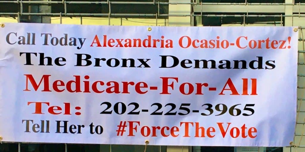 A sign asking AOC to #ForceTheVote