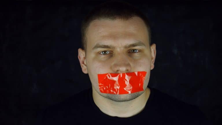 Man with tape across his mouth