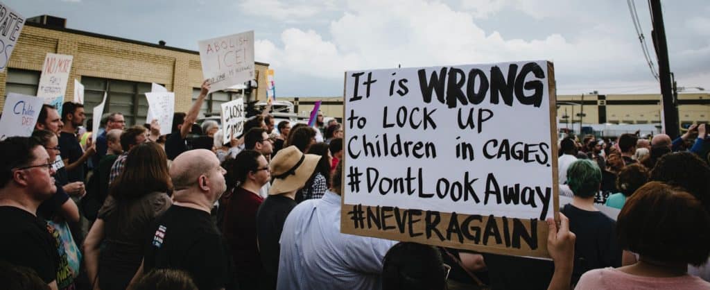 Sign against locking up immigrant kids in cages