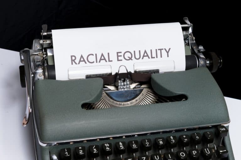 vintage typewriter, paper reads RACIAL EQUALITY